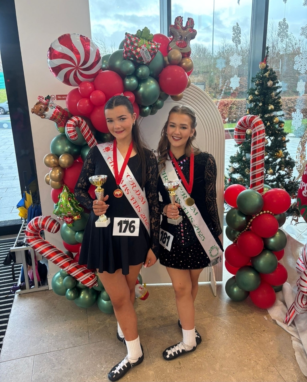 Two dancers with their trophies at a Christmas feis